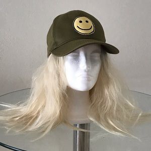 A Lauren Moshi green emoji hat